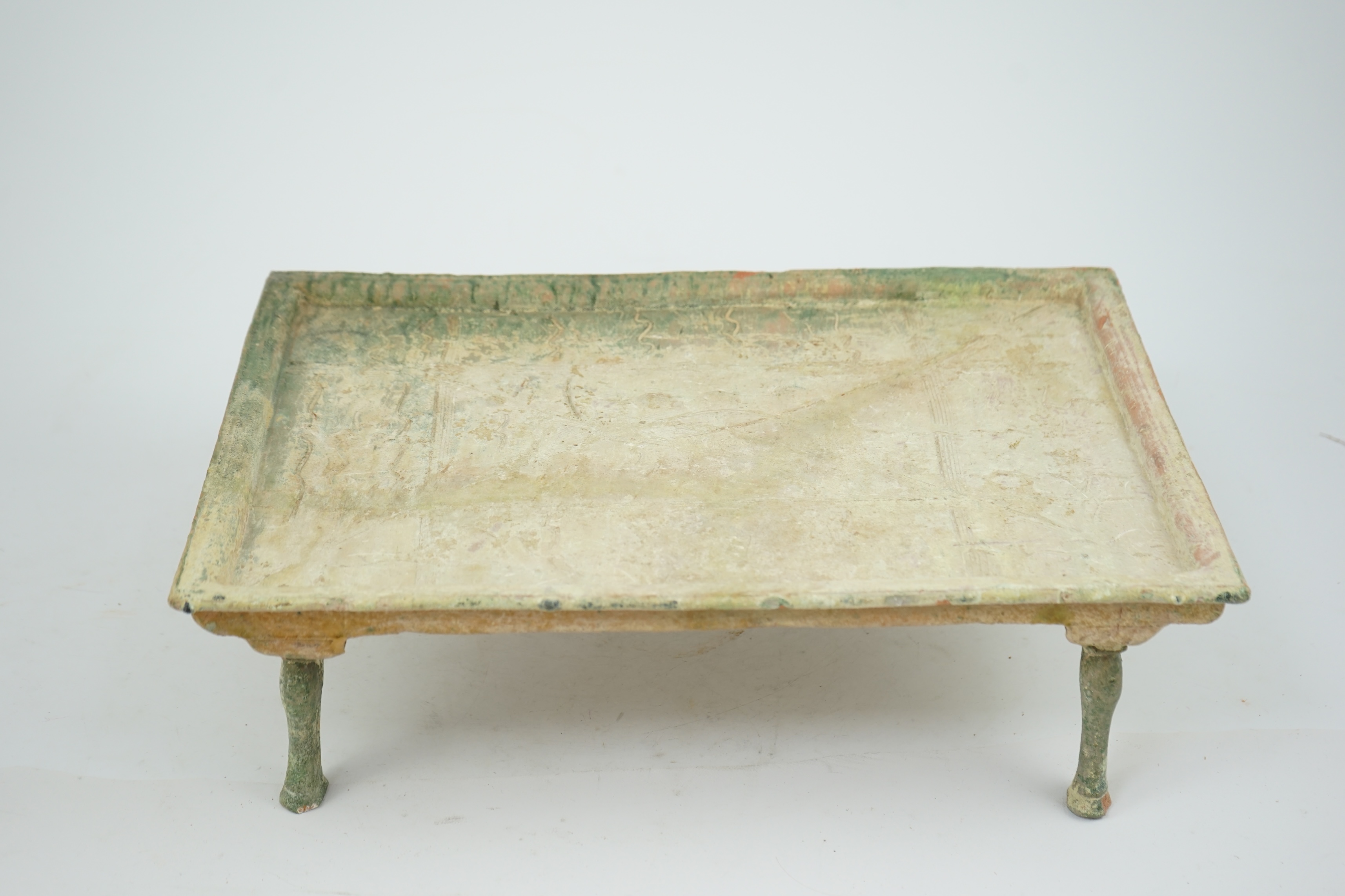 A rare Chinese glazed decorated pottery table with legs, Han Dynasty (206 BC-AD 220).